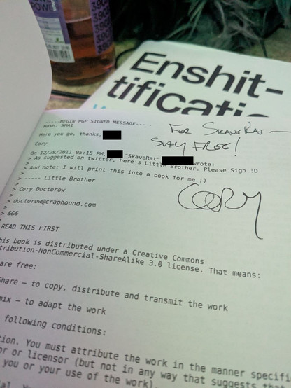 A short email conversation inside an opened book about signing the email/book.

Dated 28th of december 2011